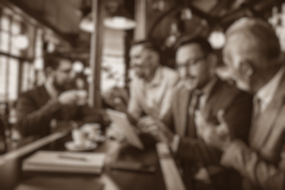 Team of colleagues working in the pub and using technology